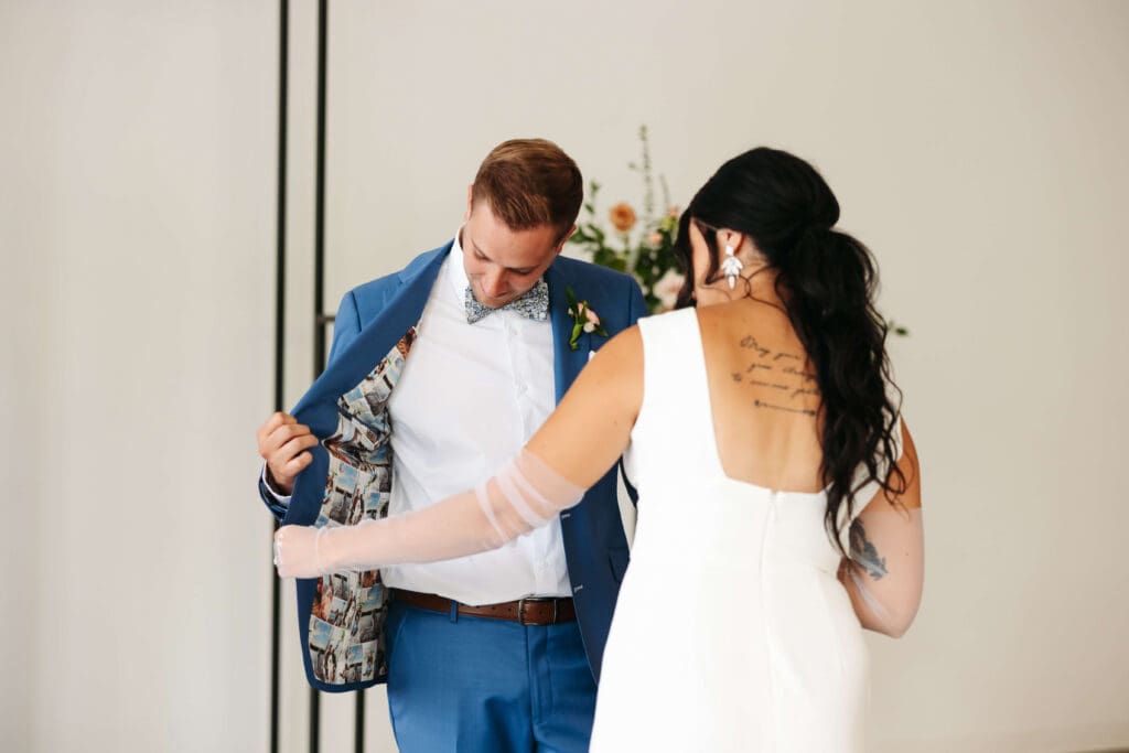 Bride takes in groom's custom suit jacket