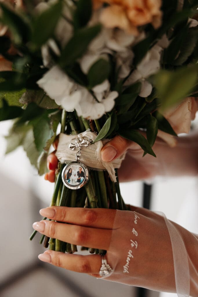 Bride holds lush bouquet with photo of her dog on it