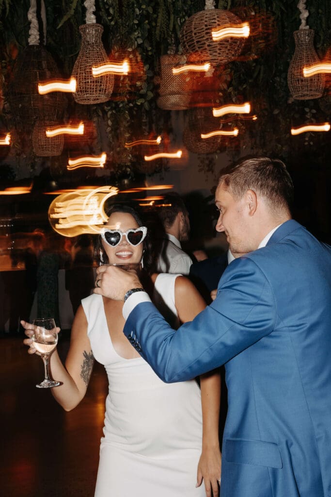 Groom gives bride a sip of his cocktail