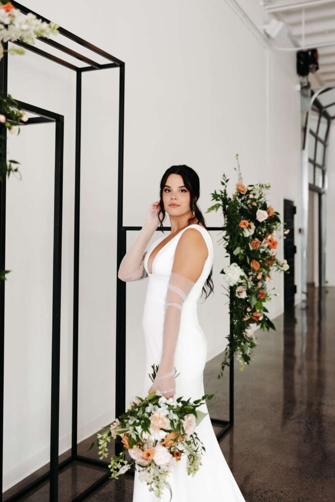 Bride poses in natural light of blank slate wedding venue Urban Daisy in Minneapolis
