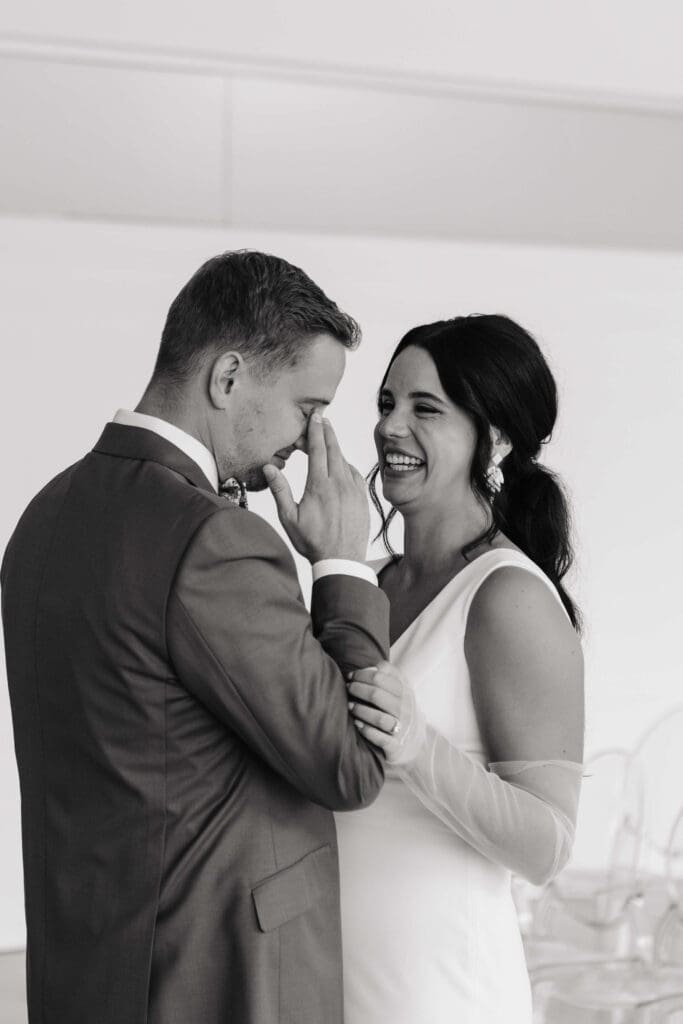 Bride laughs while groom chokes up over how beautiful his wife-to-be looks
