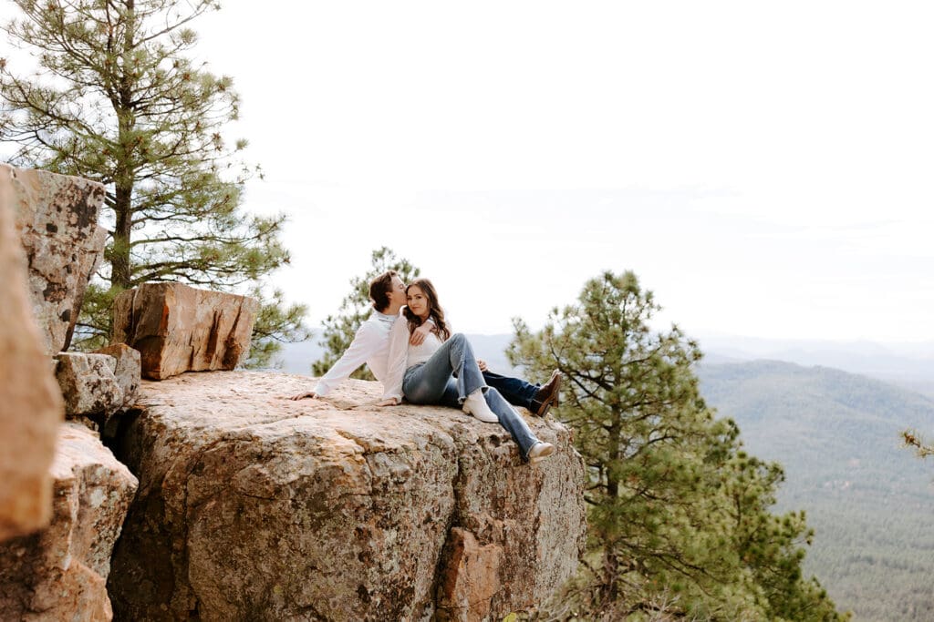 Kailey and Easton sitting on the rock Kailey had pinned for inspo—dreams do come true.