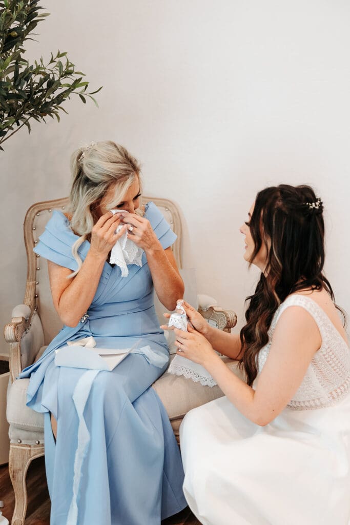 Bride and mother of the bride exchange emotional moment