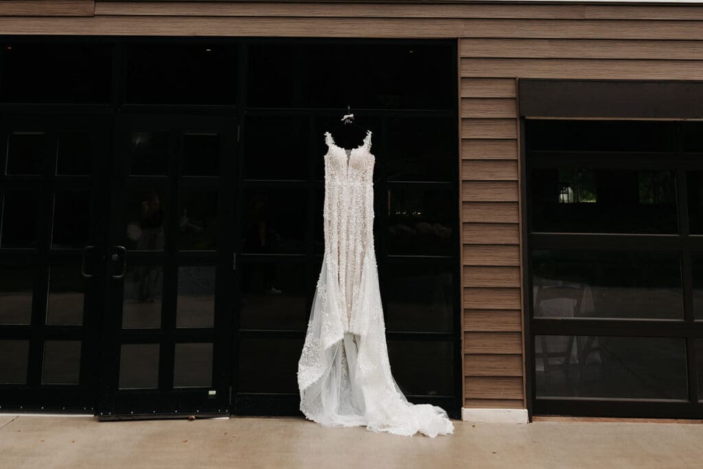 Wedding dress hanging outside La Pointe Events, a modern luxury wedding venue overlooking the St. Croix River in Minnesota.