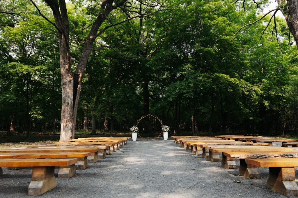 Outdoor woodland ceremony site at Equestria West at Bavaria Downs, one of the most scenic Minnesota wedding venues.