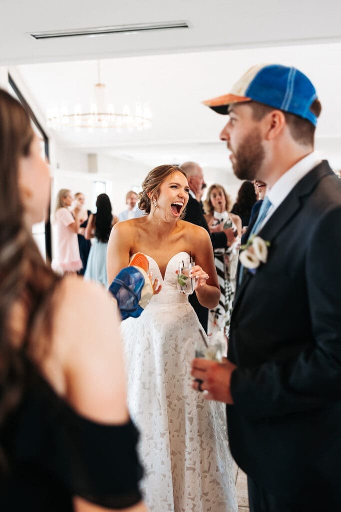 Bride greets guests during cocktail hour after building a relaxed wedding day timeline with a first look.