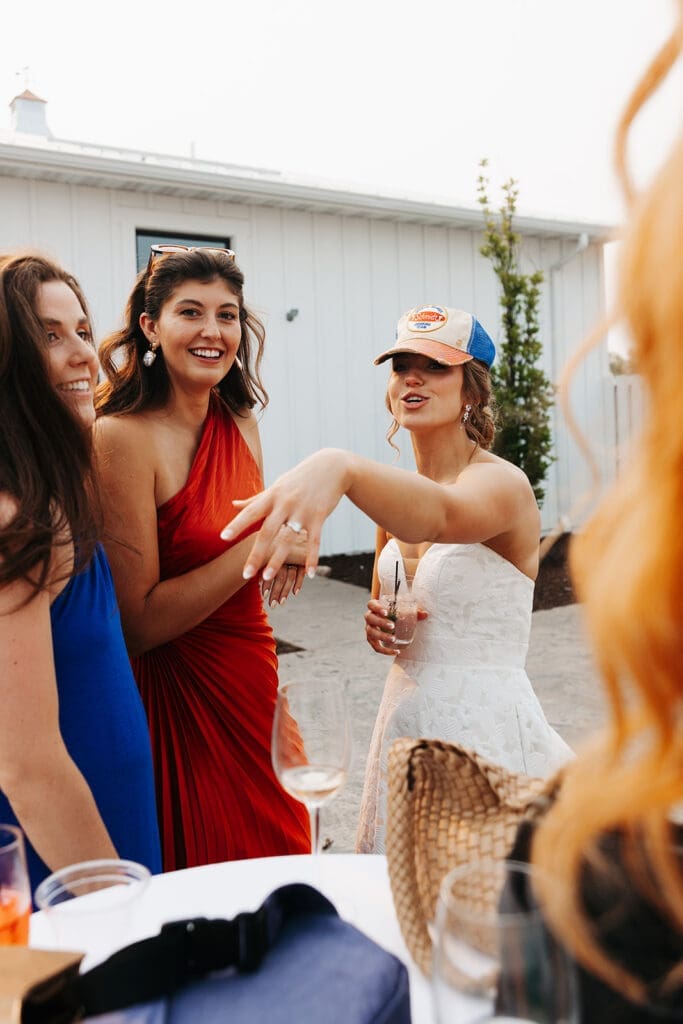 Bride laughs with friends during cocktail hour, one of the many benefits of a wedding first look.