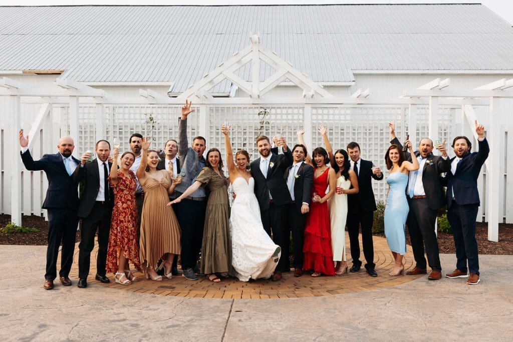 Wedding party celebrates outside after a relaxed wedding day timeline made possible by a first look.