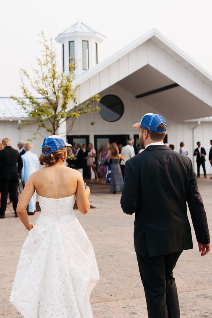 Newlyweds head toward cocktail hour together after completing portraits before the ceremony.
