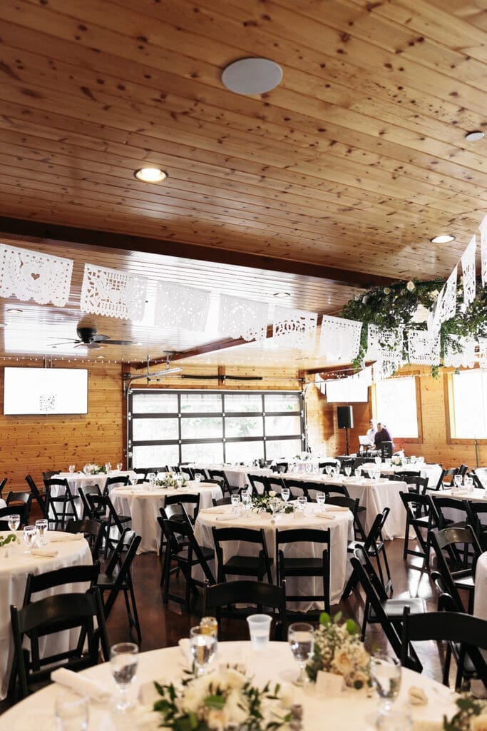 Reception space at La Pointe Events featuring warm wood ceilings, natural light, and elegant tablescapes.