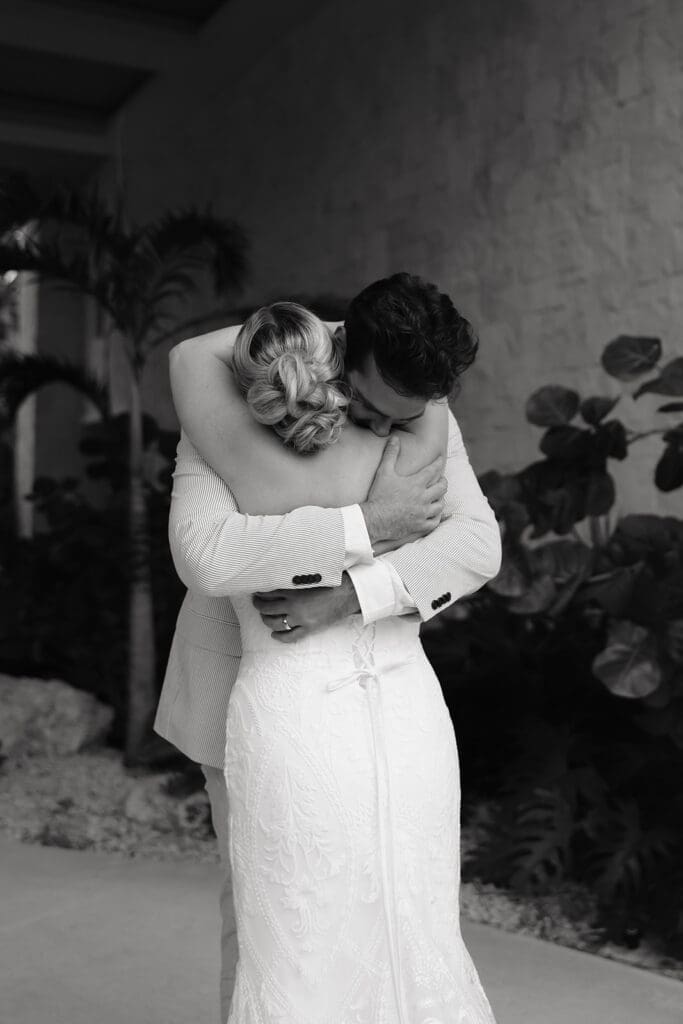 Emotional embrace during an intimate destination wedding first look before the ceremony at Secrets Playa Blanca Costa Mujeres in Mexico.