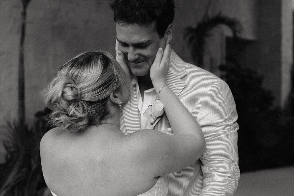 Bride smiles as she comforts her emotional groom during their wedding first look at Secrets Playa Blanca Costa Mujeres in Mexico.