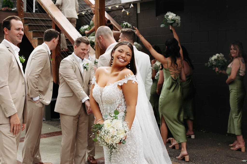 Bride smiling with her wedding party before the ceremony at La Pointe Events.