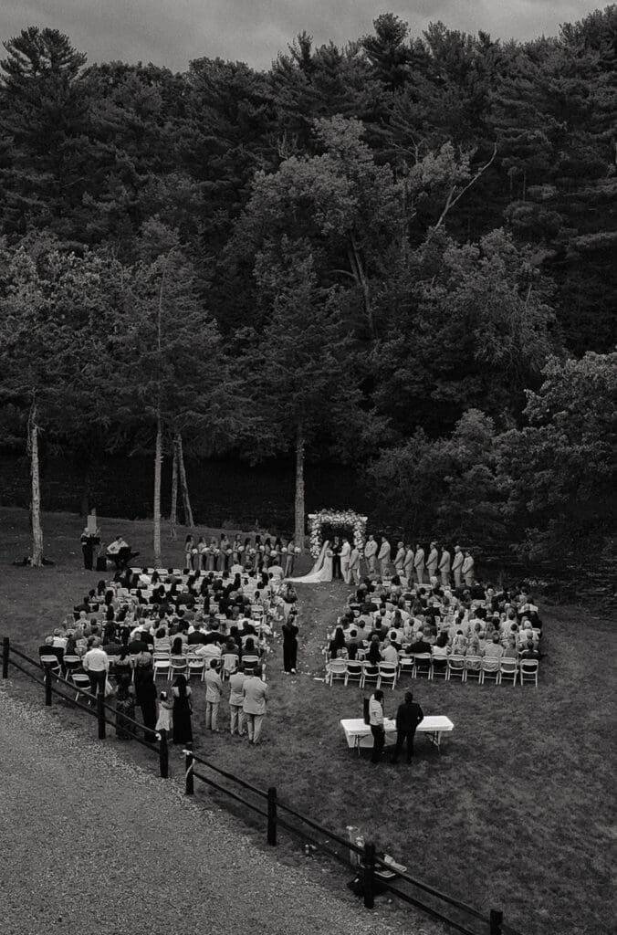 Aerial view of an outdoor riverside ceremony at La Pointe Events, one of the most scenic Minnesota wedding venues.