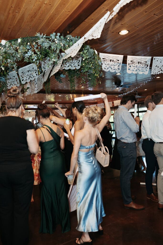 Guests celebrating on the dance floor during a lively reception at La Pointe Events.