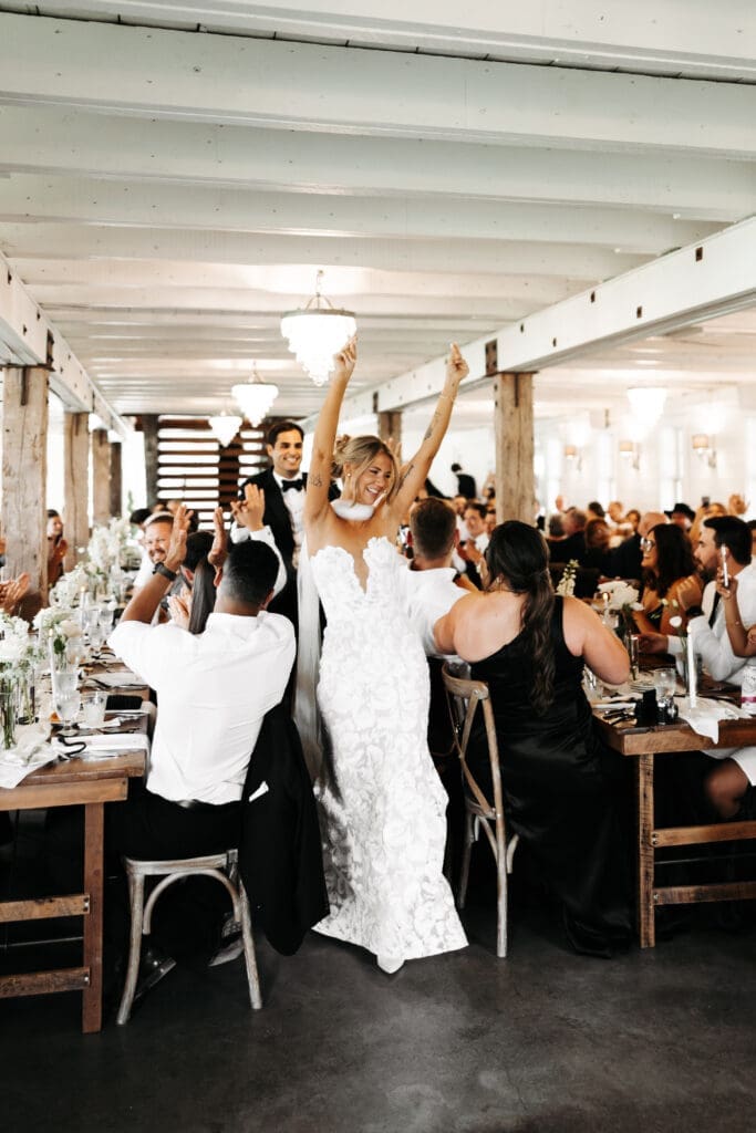 Bride and groom walking through the crowd during the reception celebration at an estate wedding venue in Minnesota.