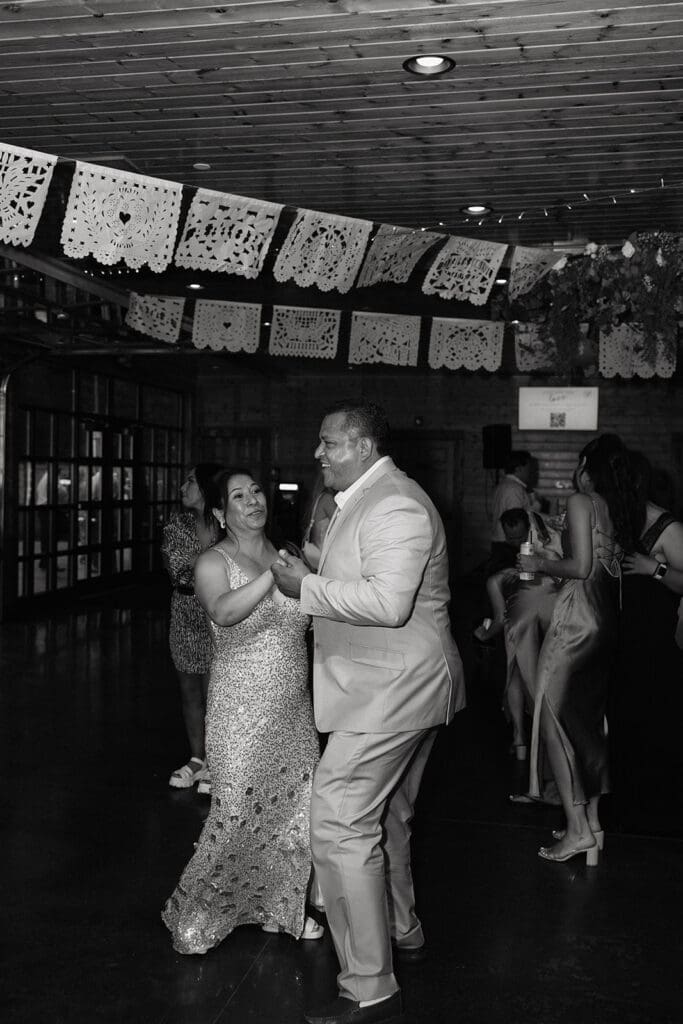 Guests dancing together during the wedding reception at La Pointe Events.
