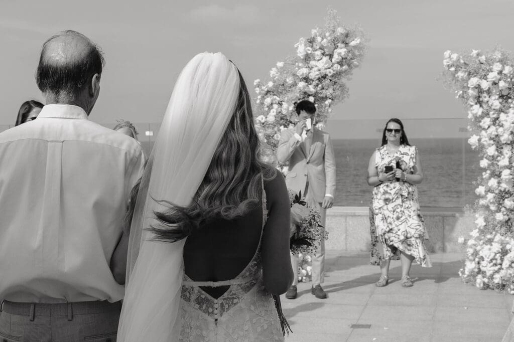 Bride walks down the aisle at Grand Palladium Select Costa Mujeres  after a private wedding first look, proving the ceremony remains just as emotional.