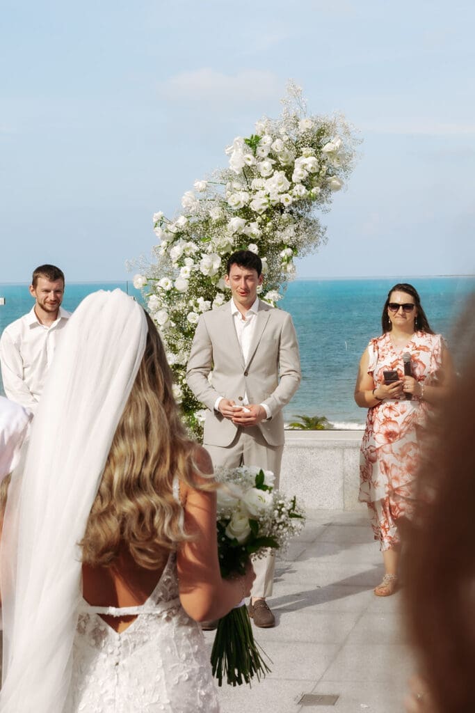 Groom waits at the ceremony with a smile after sharing an intimate wedding first look earlier in the day.